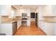 Spacious kitchen with stainless steel appliances, granite countertops, and white cabinets, blending style with practicality at 201 Lanyard Loop, Peachtree City, GA 30269