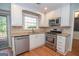 Modern kitchen with stainless steel appliances, white cabinets, and granite countertops, offering both style and functionality at 201 Lanyard Loop, Peachtree City, GA 30269