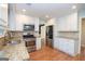 Well-appointed kitchen featuring granite countertops, stainless steel appliances, and sleek white cabinets, great for cooking at 201 Lanyard Loop, Peachtree City, GA 30269