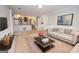 Carpeted living room with a view of the kitchen and breakfast nook at 201 Lanyard Loop, Peachtree City, GA 30269
