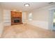 Inviting living room with a brick fireplace, built-in shelves, and neutral carpet at 201 Lanyard Loop, Peachtree City, GA 30269