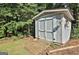 A backyard storage shed with double doors, ramp, and decorative butterfly at 201 Lanyard Loop, Peachtree City, GA 30269