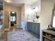 Bathroom with double vanity, shiplap accent wall, granite countertop, matte black fixtures, and round mirrors at 34 Brittany Way, Palmetto, GA 30268