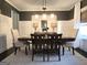 Elegant dining room with a wooden table, soft gray chairs, and decorative lighting at 34 Brittany Way, Palmetto, GA 30268