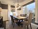 Bright dining area with a large wooden table, stylish chairs, and natural light from the window at 34 Brittany Way, Palmetto, GA 30268