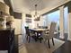 Open dining room featuring a wooden table, elegant chairs, and wainscoting at 34 Brittany Way, Palmetto, GA 30268
