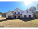 An inviting home showcasing a combination of stone, siding, and shuttered windows at 34 Brittany Way, Palmetto, GA 30268