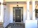 Close-up of a charming front door with decorative details and a welcoming entrance at 34 Brittany Way, Palmetto, GA 30268