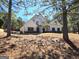 Two-story home with decorative shutters, stone accents, and a welcoming front porch on a manicured lawn at 34 Brittany Way, Palmetto, GA 30268