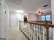 Bright hallway features neutral carpet, white doors, and wood railing leading to second floor at 34 Brittany Way, Palmetto, GA 30268