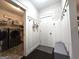 Hallway leading to laundry room with coat hooks and a door with a bench nearby at 34 Brittany Way, Palmetto, GA 30268