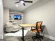 Bright home office with light hardwood floors, a desk, modern chair and shelving unit at 34 Brittany Way, Palmetto, GA 30268