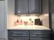 Charming kitchen decor featuring stylish gray cabinets, quartz countertops, and decorative accents at 34 Brittany Way, Palmetto, GA 30268