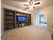 Living room features custom built-in shelving and entertainment center with mounted TV at 34 Brittany Way, Palmetto, GA 30268