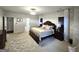 Spacious main bedroom featuring decorative walls, area rug, and a king-size bed with a decorative headboard at 34 Brittany Way, Palmetto, GA 30268