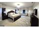 Spacious main bedroom boasts ample natural light, a cozy rug, and a comfortable bed at 34 Brittany Way, Palmetto, GA 30268