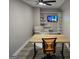 Well-lit office with modern desk, chair, and media area with floating shelving and ceiling fan at 34 Brittany Way, Palmetto, GA 30268