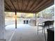 Outdoor kitchen on back patio with grill, seating and wooded backyard at 34 Brittany Way, Palmetto, GA 30268