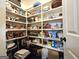 Organized pantry with multiple shelves displaying various food items and storage containers at 34 Brittany Way, Palmetto, GA 30268