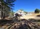 Expansive backyard of a two-story home with a covered patio, perfect for outdoor entertaining and relaxation at 34 Brittany Way, Palmetto, GA 30268