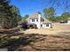 Spacious backyard with a covered patio and lush greenery surrounding the charming two-story home at 34 Brittany Way, Palmetto, GA 30268