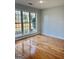 Bright bedroom featuring hardwood floors and a large window at 410 Oakpark Ter, Mcdonough, GA 30253