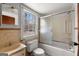 Cozy bathroom featuring a tub-shower, toilet, vanity with mirror, and natural light from the window at 5211 Old Monticello Se St, Covington, GA 30014