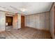 Bedroom with unique wood-look wall paneling and view to the kitchen at 5211 Old Monticello Se St, Covington, GA 30014