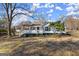 Lovely one-story home with black shutters, framed by beautiful mature trees at 5211 Old Monticello Se St, Covington, GA 30014