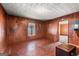 Cozy living room featuring wood paneling and natural light from the window at 5211 Old Monticello Se St, Covington, GA 30014