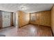 Living room features tiled flooring, wood-paneled walls, and a doorway leading to the exterior at 5211 Old Monticello Se St, Covington, GA 30014