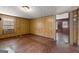 Living room featuring wood-paneled walls, tiled floor, a window with AC, and doorway leading to another room at 5211 Old Monticello Se St, Covington, GA 30014