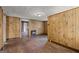 Living room showcases wood-paneled walls, tiled floor, and an open doorway to the next room at 5211 Old Monticello Se St, Covington, GA 30014