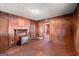 Cozy living room featuring wood paneling, fireplace, and access to other rooms at 5211 Old Monticello Se St, Covington, GA 30014