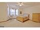 Well-lit bedroom with a cozy bed, comfortable chair, and natural light from the windows at 300 Planceer Pl, Peachtree City, GA 30269