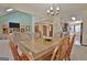 Cozy dining room with a wood table and chairs, chandelier, and a view to the living room and kitchen at 300 Planceer Pl, Peachtree City, GA 30269