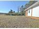 Expansive backyard featuring brick accents, a partially wooded area, and ample space for outdoor activities at 940 New Hope Rd, Fayetteville, GA 30214