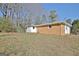 View of the backyard highlighting the brick home's exterior, fenced area, and potential for outdoor enjoyment at 940 New Hope Rd, Fayetteville, GA 30214