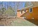 Brick home exterior and fenced backyard with a wooden bench and a partially covered patio area at 940 New Hope Rd, Fayetteville, GA 30214