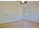 Bedroom showcasing wood floors, a ceiling fan, a window, and a white door at 940 New Hope Rd, Fayetteville, GA 30214