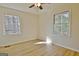 Bedroom with wood floors, two windows allowing in ample natural light, and neutral walls at 940 New Hope Rd, Fayetteville, GA 30214