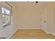 Bright bedroom featuring wood floors, one window, and a closet with a white door at 940 New Hope Rd, Fayetteville, GA 30214