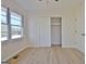 Spacious bedroom features wood floors, window with a view, closet, and white doors at 940 New Hope Rd, Fayetteville, GA 30214