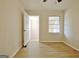 Light-filled bedroom features a window, hardwood floors and closet at 940 New Hope Rd, Fayetteville, GA 30214