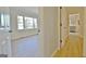 Bright hallway features light wood floors, leading to a bedroom with a large window and a glimpse of the kitchen at 940 New Hope Rd, Fayetteville, GA 30214