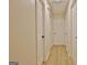 Bright hallway featuring hardwood floors and a row of doors at 940 New Hope Rd, Fayetteville, GA 30214