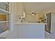 Bright kitchen features white cabinets, stainless steel appliances, and a breakfast bar overlooking the backyard at 940 New Hope Rd, Fayetteville, GA 30214