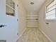 Small utility room with shelves and window features luxury vinyl tile flooring at 940 New Hope Rd, Fayetteville, GA 30214