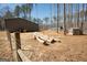 View of the home's backyard with mature trees, a small shed, and additional outbuilding at 337 Paynes Lake Rd, Carrollton, GA 30116