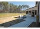 Backyard view featuring a patio with lounge chairs overlooking the home's lawn at 337 Paynes Lake Rd, Carrollton, GA 30116